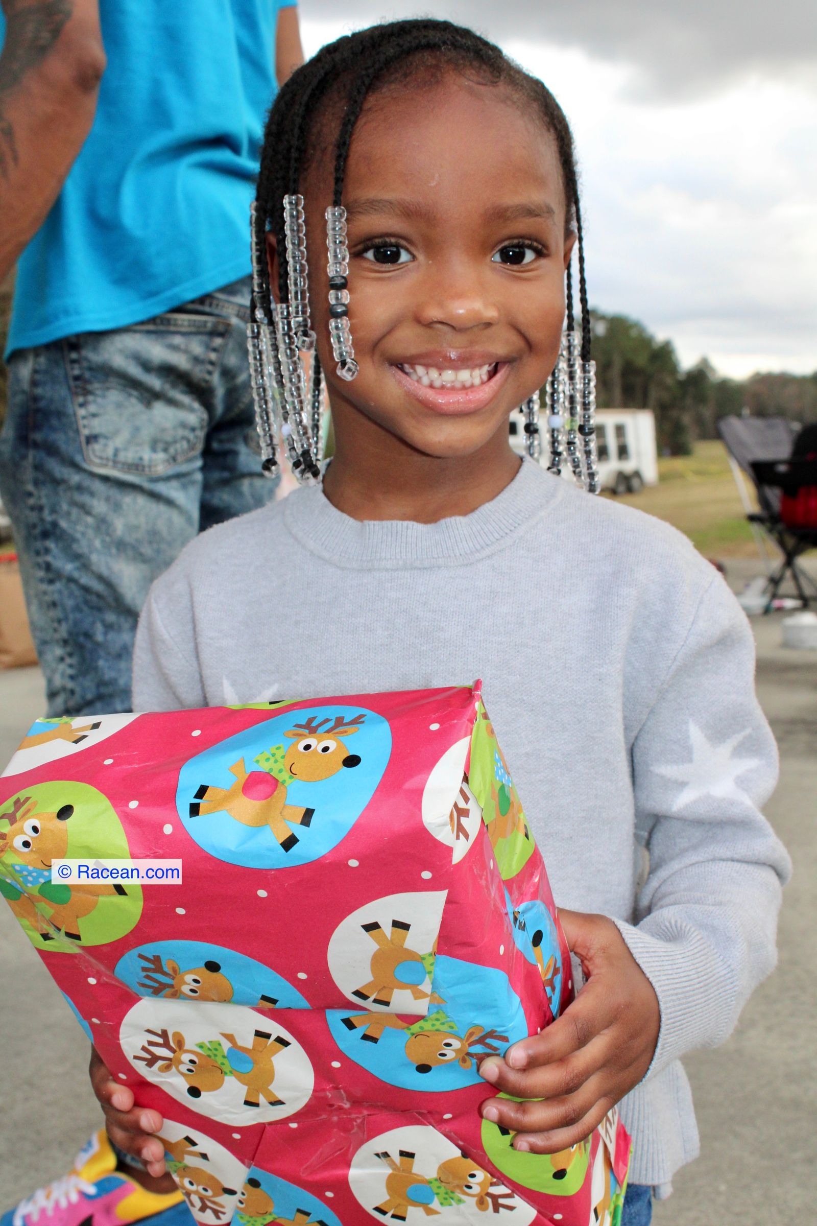 A girl smiling with her gift at a community festival
