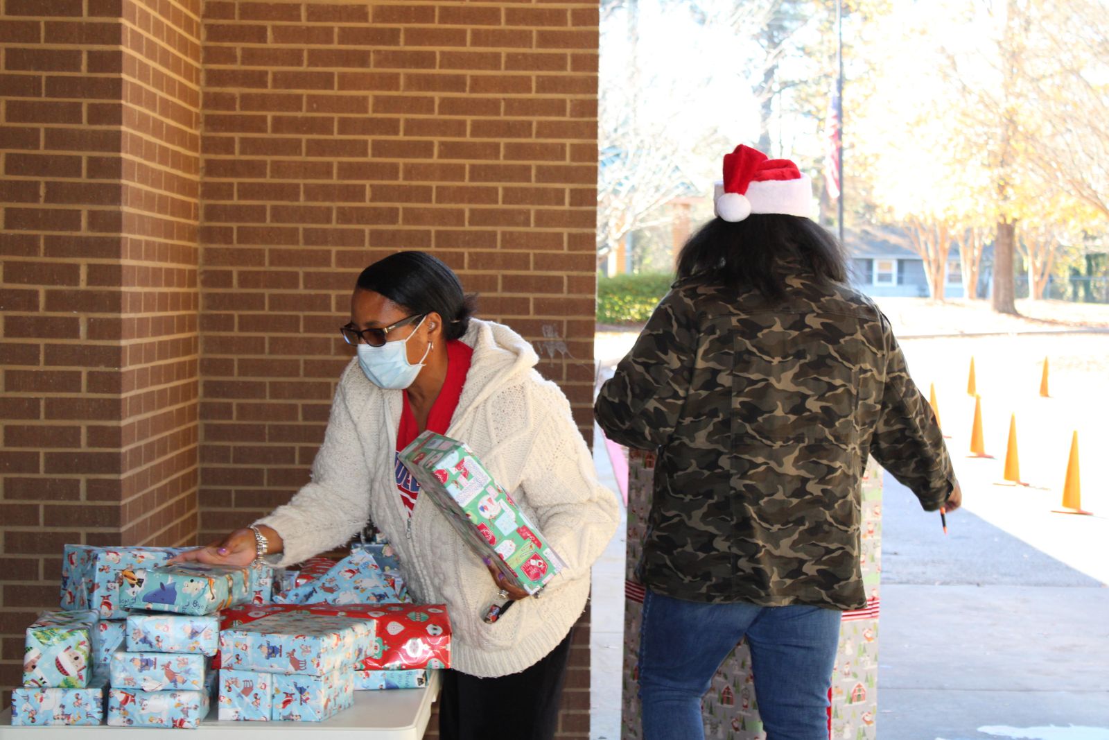 A volunteer handing out gifts at a school